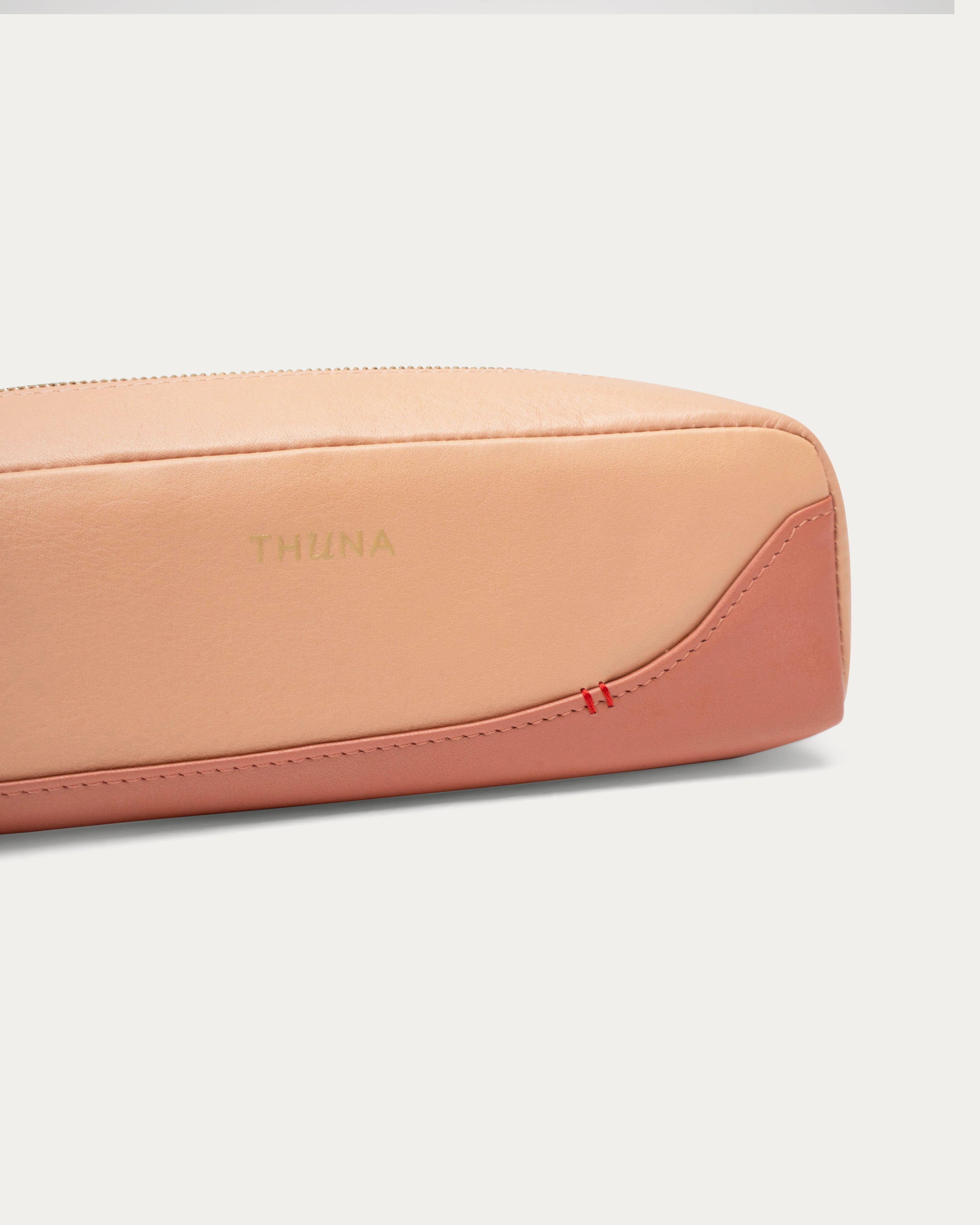 Two-tone beige and pink pouch with a red zipper on a white background - Kuwait BAGS - KSA bags 