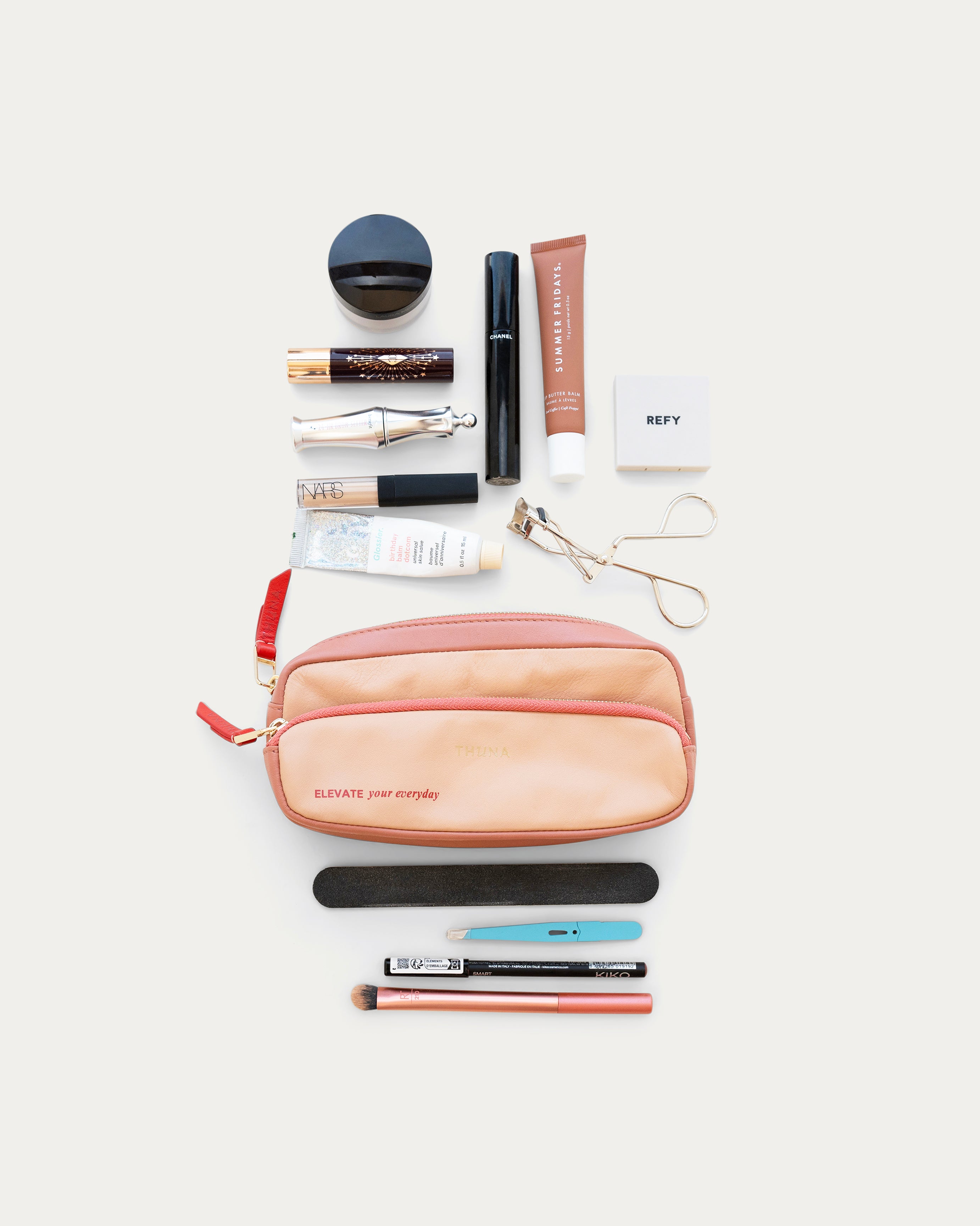 Beige and red rectangular pouch with 'Elevate your everyday' text on a light gray background - Kuwait bags - KSA Bags 