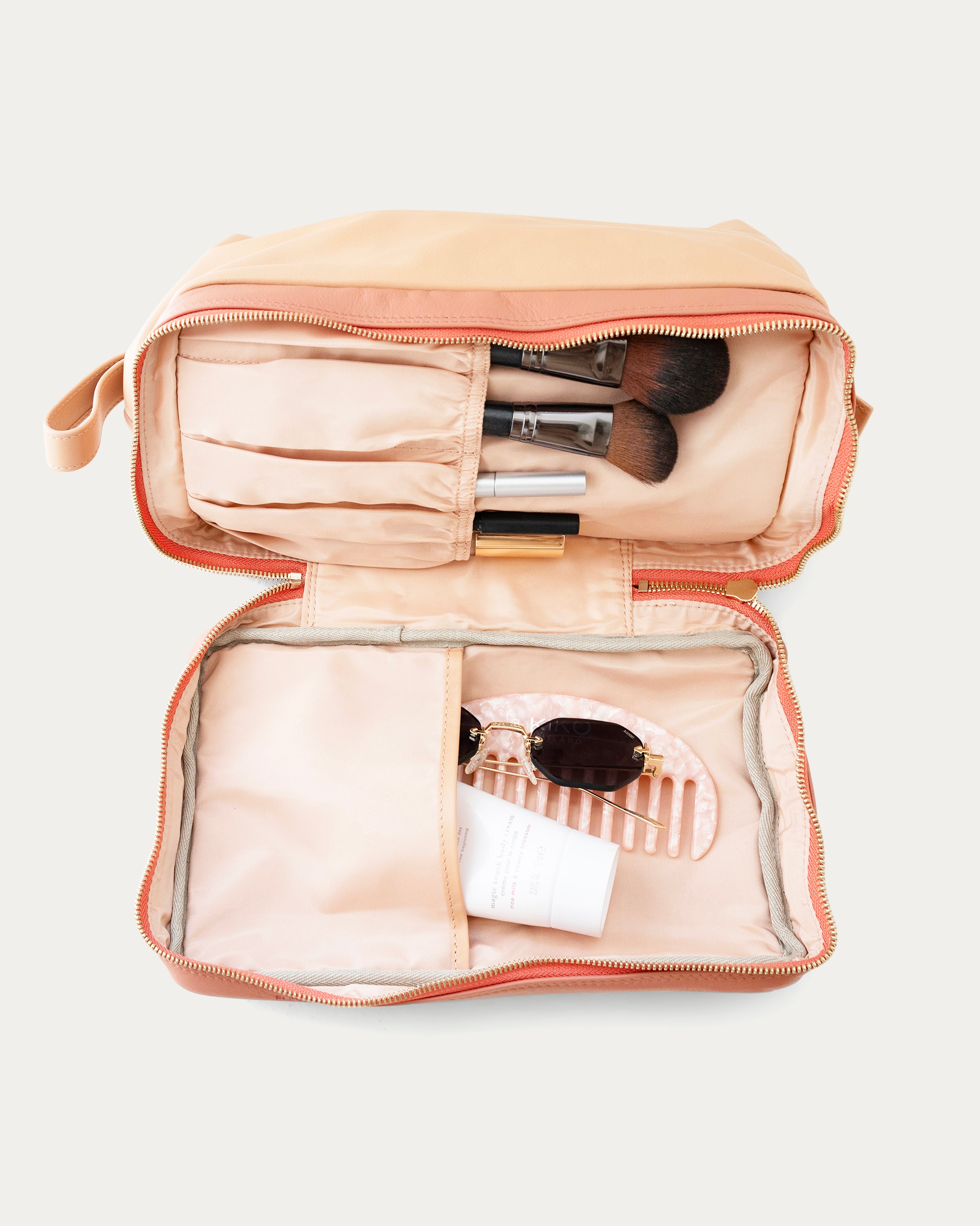 Beige makeup bag with gold zipper on a light gray background - Kuwait bags - KSA