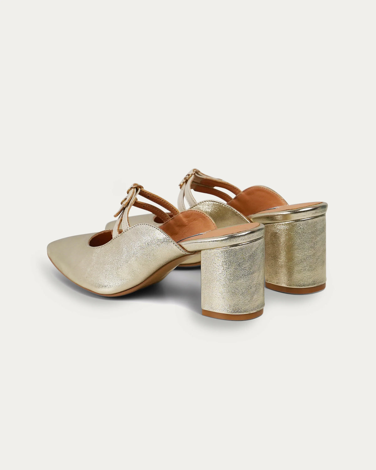 Gold metallic mules with block heels and T-strap design, handmade for modern women's everyday style.