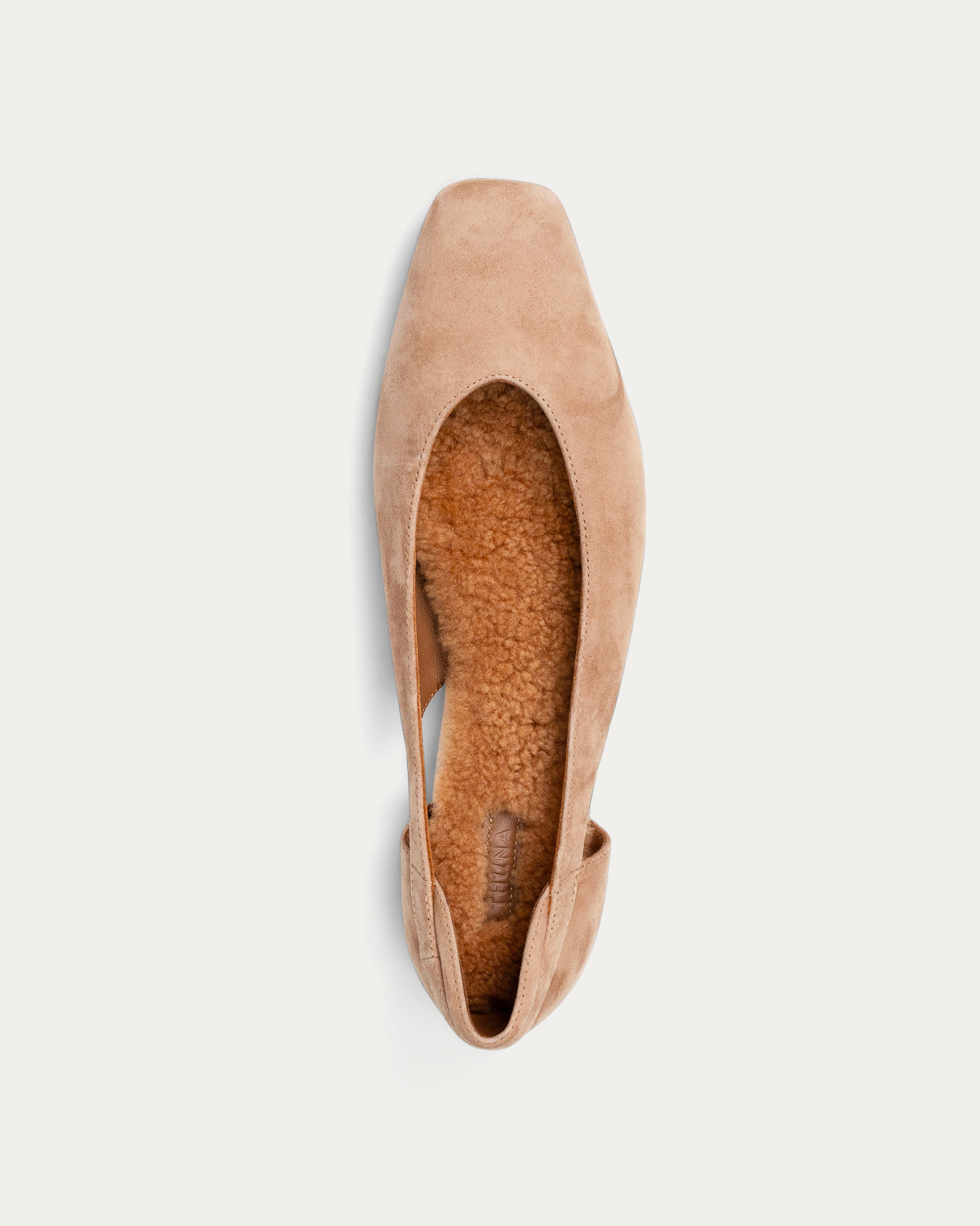 Beige flat shoe on a light beige background