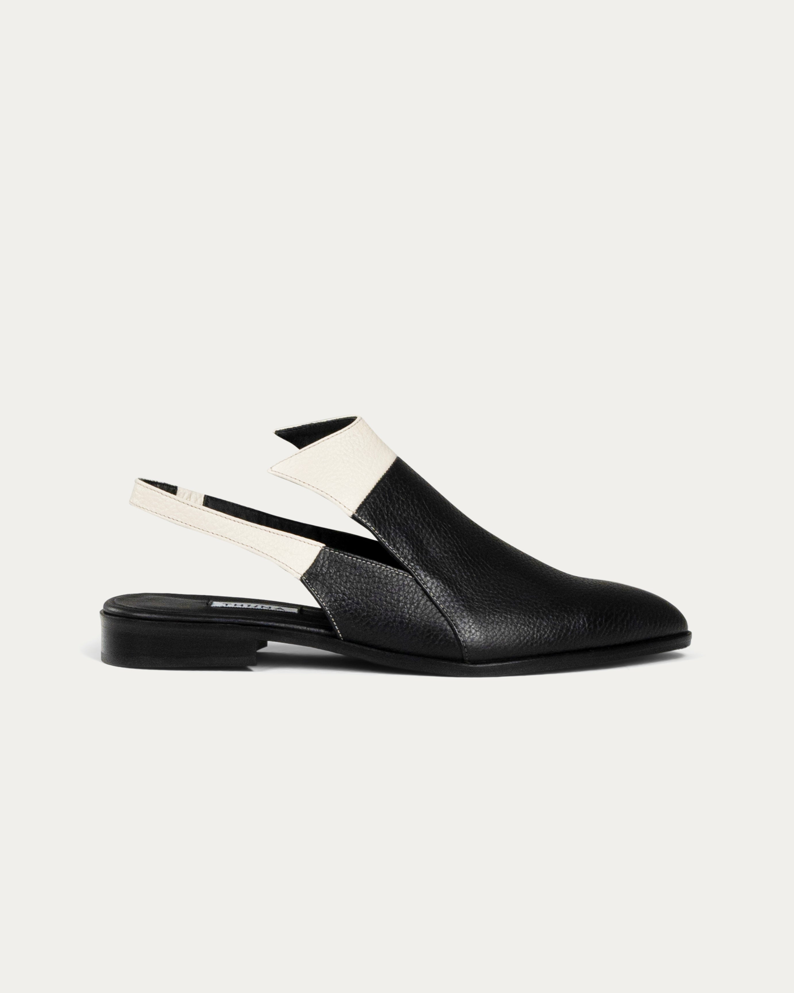 Black slingback shoes with white accents on a light gray background - THUNA Shoes - Kuwait - KSA
