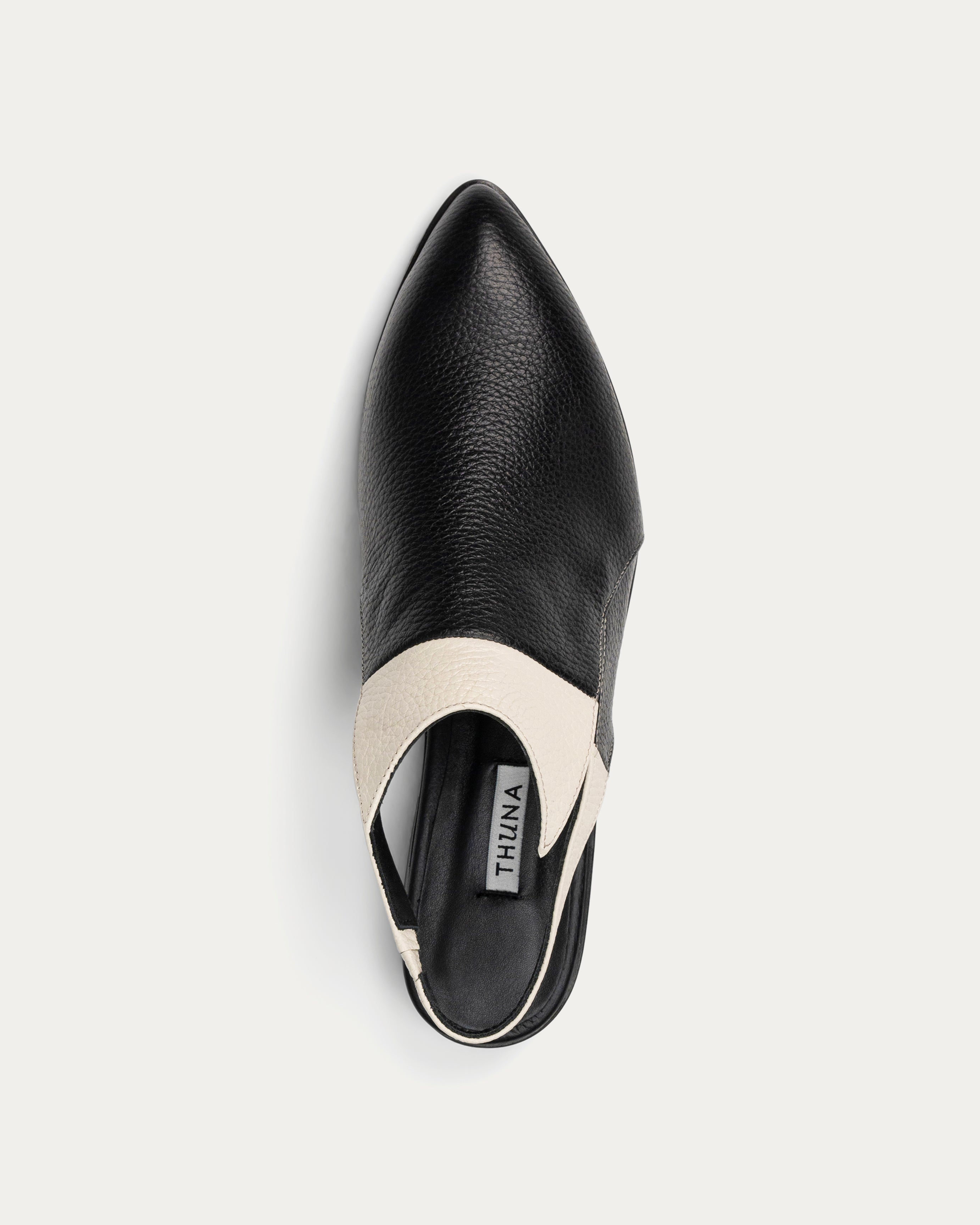 Black slingback shoes with white accents on a light gray background - THUNA Shoes - Kuwait - KSA